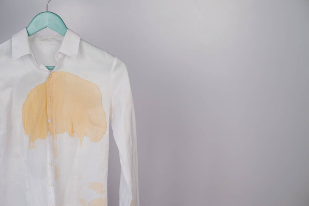Womens office white shirt with a stain of coffee on a white background. Copy space - Foto, Imagem