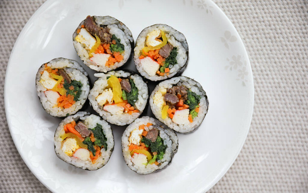 Kimbap is a traditional Korean dish made of rice, vegetables, and meat or seafood rolled in seaweed. It represents the country's rich culinary heritage and cultural diversity - Photo, image
