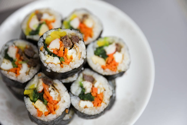 Kimbap is a traditional Korean dish made of rice, vegetables, and meat or seafood rolled in seaweed. It represents the country's rich culinary heritage and cultural diversity - 写真・画像