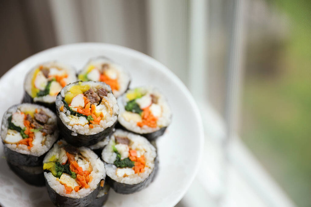 Kimbap is a traditional Korean dish made of rice, vegetables, and meat or seafood rolled in seaweed. It represents the country's rich culinary heritage and cultural diversity - 写真・画像