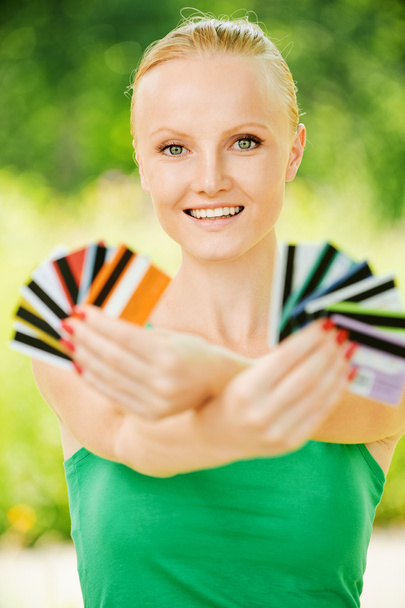 Portrait of woman holding colourful cards - Photo, Image