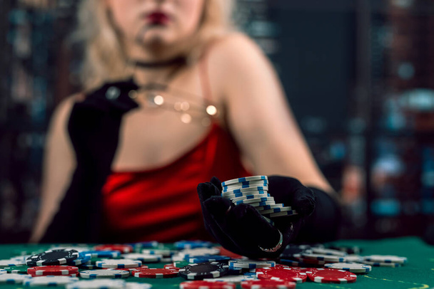 girl wear red dress play poker in a casino.  Wiiner, gambling concept - Valokuva, kuva