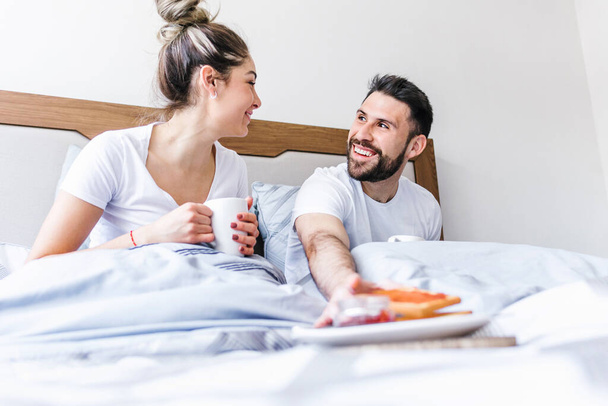 latin couple having breakfast on bed at home in Mexico, hispanic people in Latin America - Photo, Image
