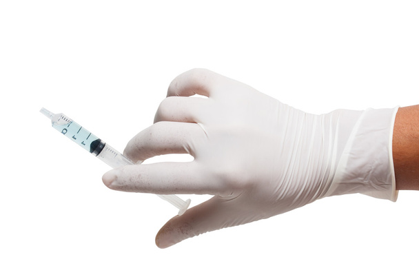 Someone wearing medical gloves holding a syringe - Fotografie, Obrázek