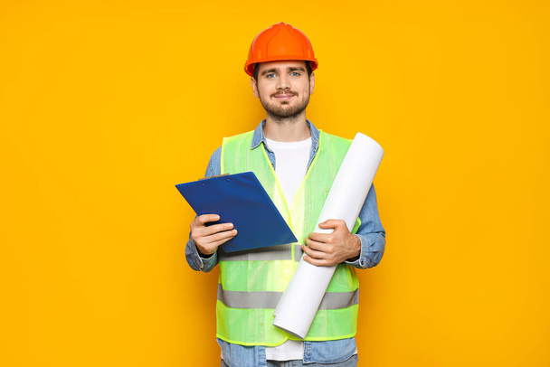 Young man civil engineer on yellow background - Photo, Image