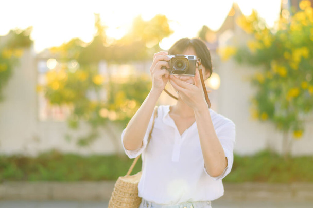 Asian woman traveler using camera. Asia summer tourism concept - Photo, image