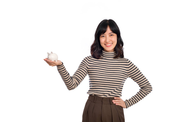 Portrait of young Asian woman holding white piggy bank isolated on white background, Financial and bank saving money concept - Valokuva, kuva