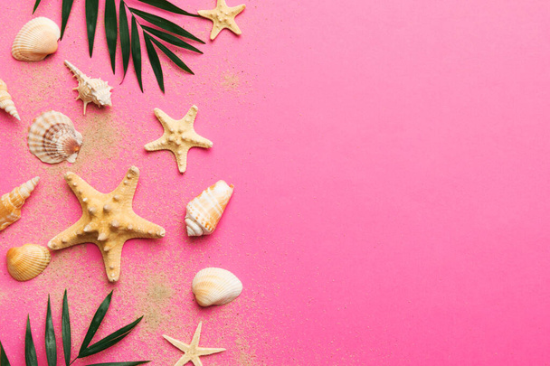 Summer time concept Flat lay composition with beautiful starfish and sea shells on colored table, top view with copy space for text. - Photo, Image