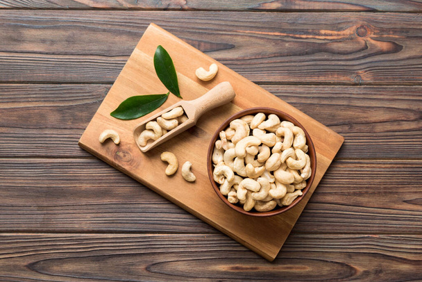 cashew nuts in wooden bowl on table background. top view. Space for text. Healthy food - Фото, зображення