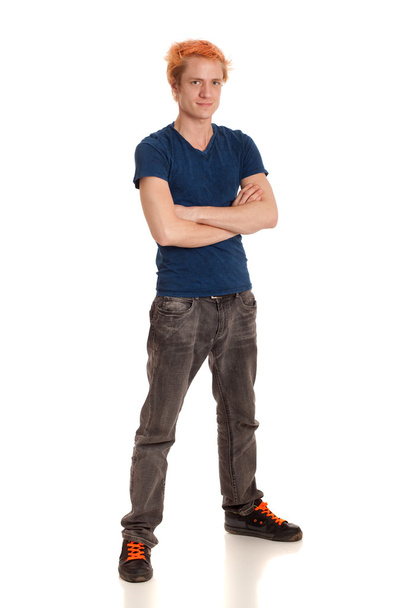 Young man in a blue shirt and jeans. Studio shot over white. - Foto, Imagem
