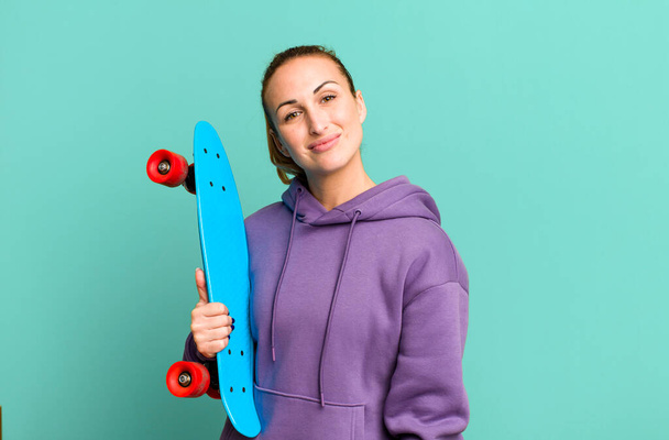 young pretty woman with a skate board - Fotó, kép