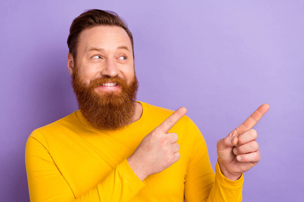 Photo portrait of young satisfied man brutal direct finger novelty wear yellow jumper shopping day ad isolated on purple color background. - Foto, Bild