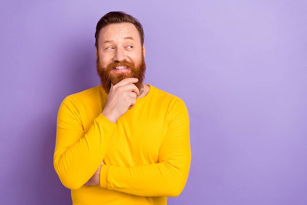 Photo of young happy confident businessman wear yellow trendy long sleeve touch chin minded look mockup isolated on purple color background. - Фото, изображение
