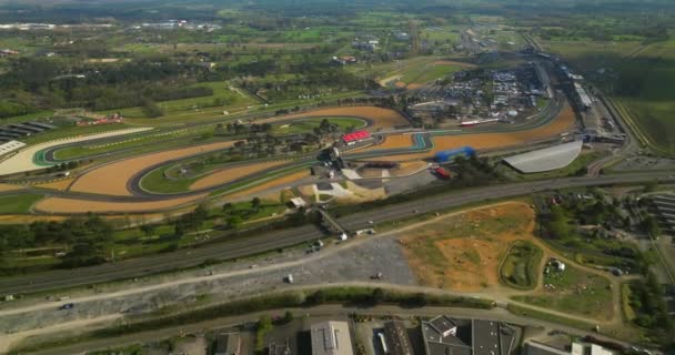 An aerial view of the race track hosting the 24 Hour Endurance Car Race at Le Mans. The famous winding track in Europe. Car racing in France. - Footage, Video