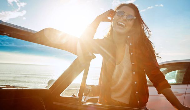 The road tripping life is the best life. a happy young woman enjoying a summers road trip - Fotoğraf, Görsel