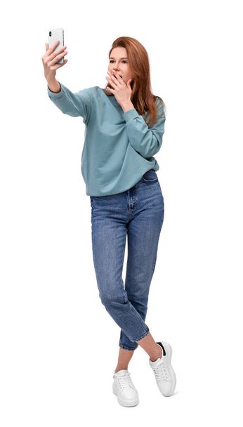 Beautiful woman taking selfie on white background - Foto, Bild