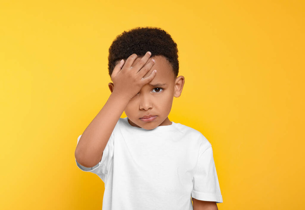 Portrait of emotional African-American boy on yellow background - Foto, afbeelding