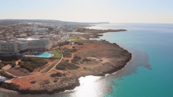 Ayia Napa, Cyprus - 15th april, 2023: birds eye view fly over greek side Cyprus island Ayia Napa bay with turquoise beaches and hotel resorts. Famous holiday destination - Footage, Video