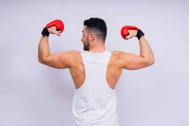 Young caucasian handsome man isolated on a white background with boxing gloves - Foto, afbeelding
