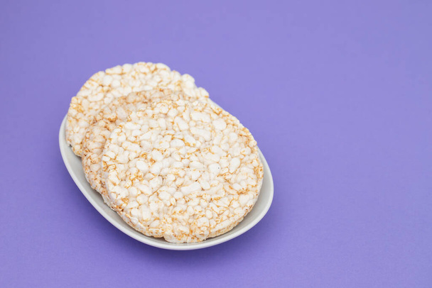 Few crunchy rice cakes on white small dish - Photo, Image