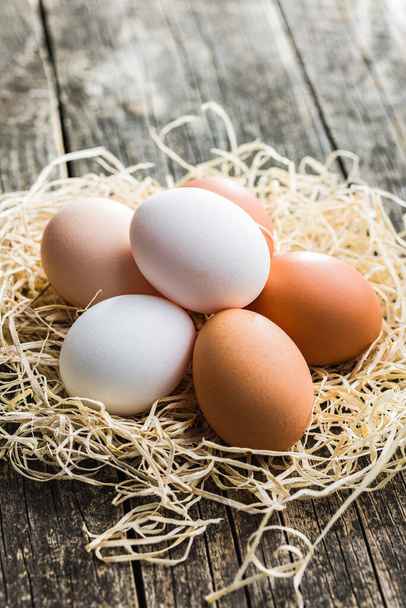 Whole chicken eggs on the wooden table. - Φωτογραφία, εικόνα
