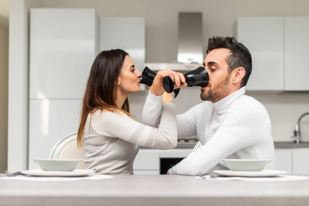 Couple toasting wineglasses at home, quarantine concept - Fotó, kép