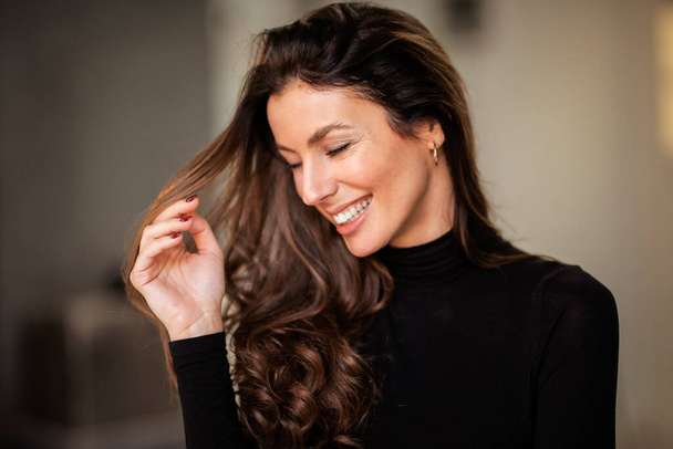 Close-up portrait of brunette haired woman cheerful smiling  - Фото, зображення