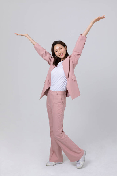 business concept korean young woman, doing hand motion. studio shot - Photo, Image