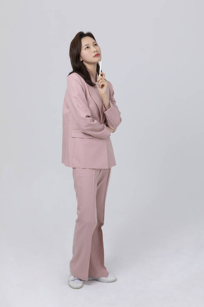 business concept korean young woman, worrying. studio shot - 写真・画像