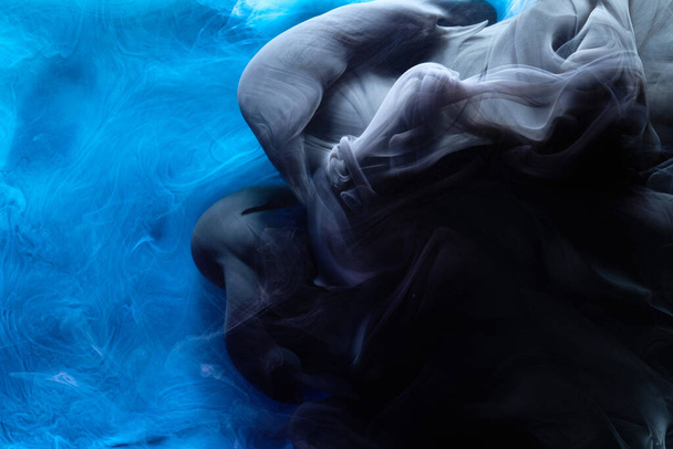 Blue black contrast liquid art background. Paint ink explosion, abstract clouds of smoke mock-up, watercolor underwater - Foto, afbeelding