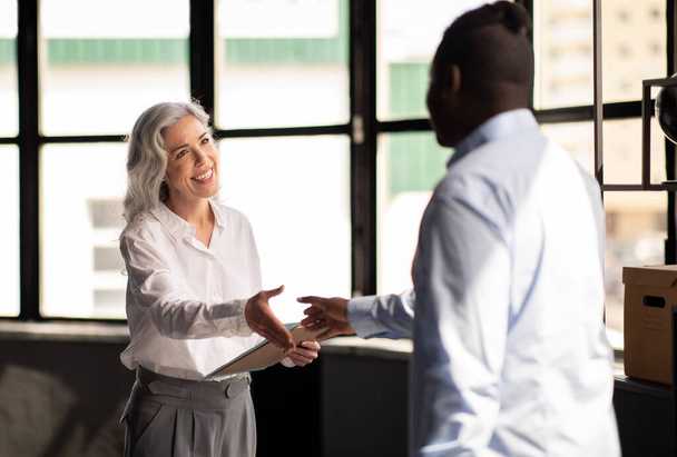 Headhunting. Cheerful HR Manager Woman Shaking Hands With Male Job Applicant In Modern Office. Successful Business Meeting And Job Interview Concept. Selective Focus On Businesswoman - Foto, imagen
