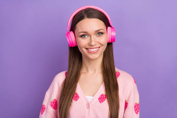 Photo of cheerful positive girl wear berry print cardigan headphones enjoying music isolated violet color background. - Фото, изображение