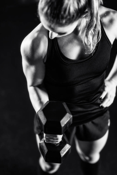 Cross training. Young woman exercising with dumbbells - Foto, Imagem