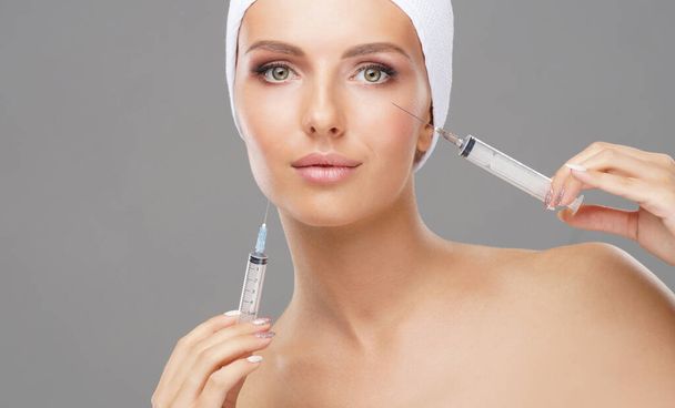 Beauty injection in a face of a young woman. Plastic surgery, skin lifting and aesthetic medicine concept. - Fotó, kép