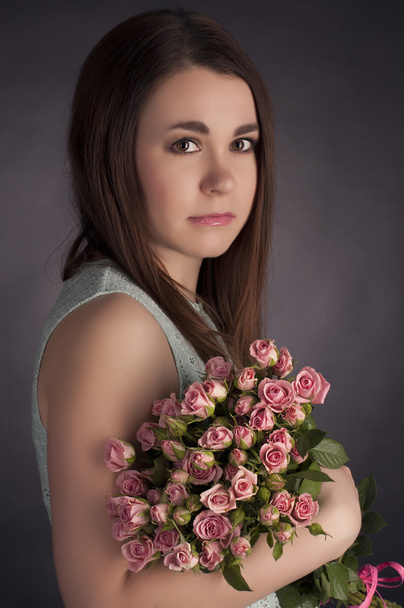 Portrait of beautiful charming brunette woman with punk flowers. Fashion photo - Foto, Imagen