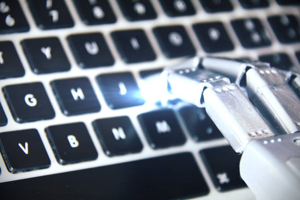 Robot hand working on a computer keyboard . - Fotó, kép