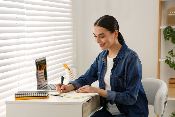 Woman studying on laptop at home. Online translation course - Valokuva, kuva