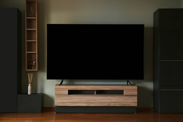Modern TV set on table in room. Interior design - Φωτογραφία, εικόνα