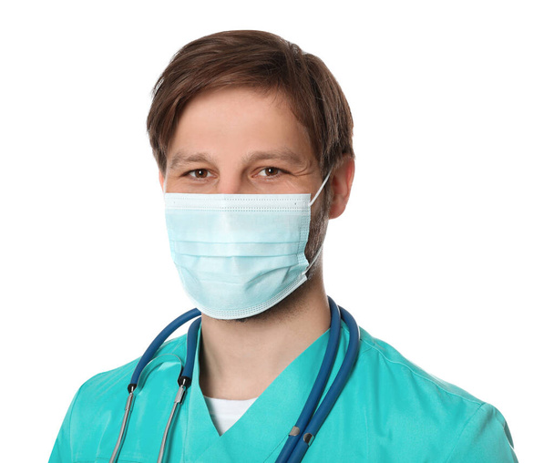 Doctor or medical assistant (male nurse) with protective mask and stethoscope on white background - Valokuva, kuva