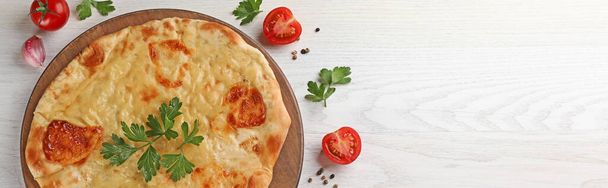 Delicious Megrelian khachapuri served on white wooden table, flat lay. Banner design with space for text - Foto, Imagen