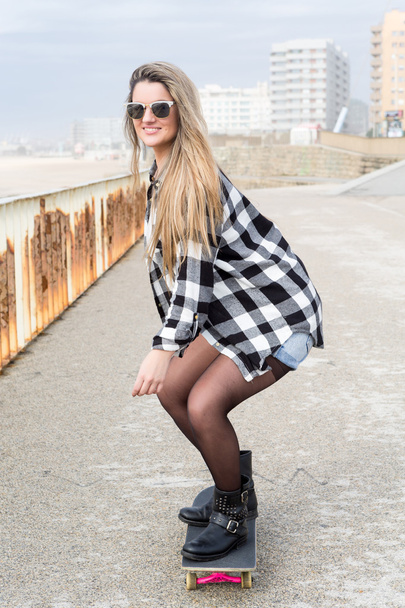 Beautiful young woman with skateboard - Photo, Image