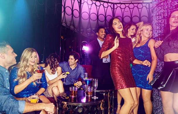 Work hard, party harder. a group of young adults enjoying themselves while out in a nightclub - Photo, Image