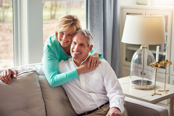 Living our happily ever after. a mature couple relaxing together at home - Foto, Imagem