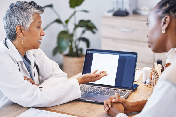 Showing results, talking and a doctor with a black woman for notes, plan and strategy for health. Discussion, help and a mature female gp speaking to an African patient about medical progress. - 写真・画像
