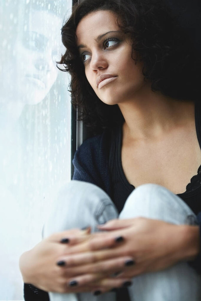 Depression, rain and thinking with woman by window for sad, tired and lonely. Anxiety, mental health and exhausted with female contemplating at home for broken heart, disappointed and fear mockup. - Photo, Image