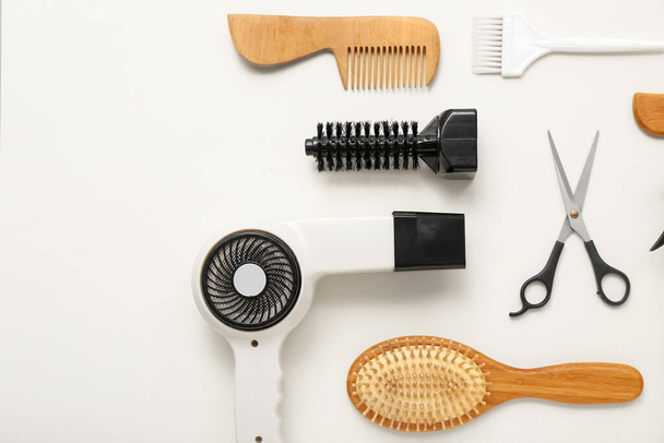 Composition with hairdressing accessories on light background - Photo, Image