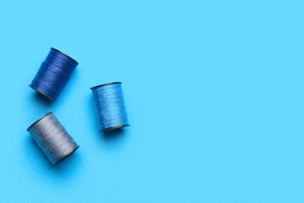 Sewing spools on color background - Fotó, kép