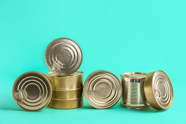 Tin cans with fish on turquoise background - Foto, immagini