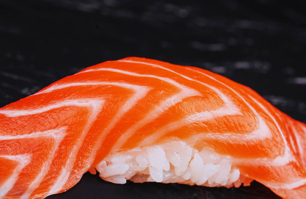 Salmon nigiri sushi on black stone - Photo, Image