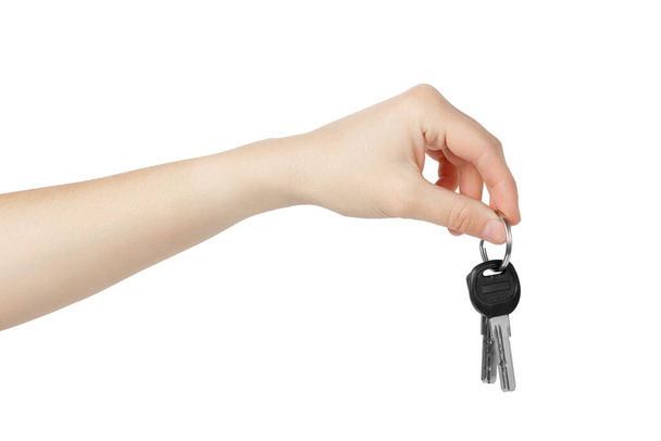 Hand holding keys to apartment on white background. High quality photo - Foto, imagen